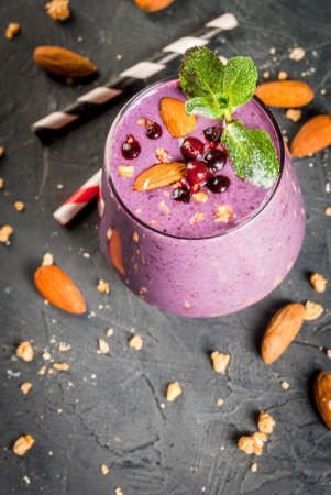 Healthy food. Dietary breakfast, snack. Berry smoothies with granola, black currant, blueberries and...