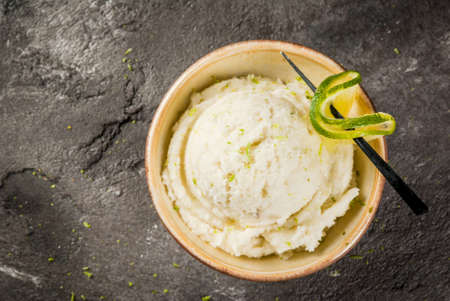 Refreshing lime sorbet in little bowl, one portion, with lime garnish On an old gray concrete table. Copy space top viewの写真素材