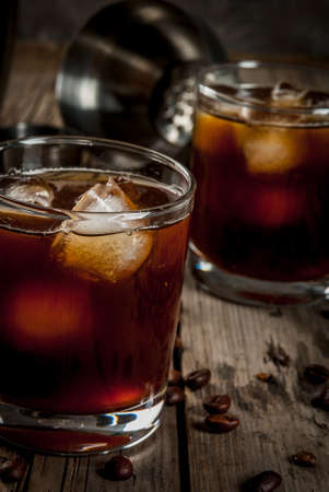 Alcohol. Drinks, Boozy Black Russian cocktail with vodka and coffee liquor on rustic wooden table.