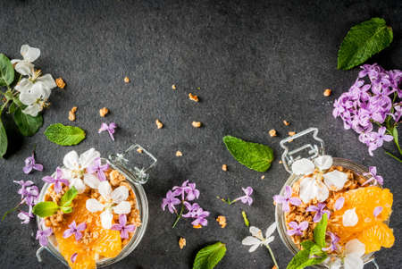 Trendy exotic food. Vegan paleo diet. Breakfast. Yoghurt with granola, fillet slices of orange, mint...