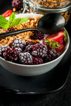 Healthy breakfast. Summer berries and fruits. Homemade Greek yogurt with granola, blackberries,...