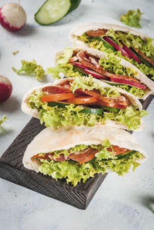 Snack. Takeaway food, street fast food. Pita bread sandwich with fresh vegetables lettuce, cucumber,...