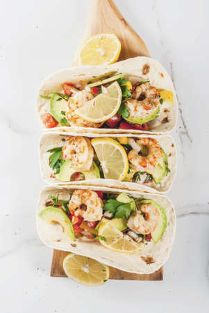 Seafood. Mexican food. Tortilla tacos with traditional homemade salsa salad, parsley, fresh lemon,...