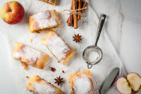 Home autumn, summer baking, puff pastries. Apple strudel with nuts, raisins, cinnamon and powdered...