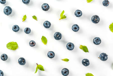 Food preparation background. Isolated, Fresh raw organic blueberry and mint on white background, top view, pattern, copy spaceの写真素材