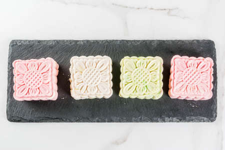 Asian, Japanian food,  Traditional sweet dessert multicolored no bake snow skin mooncakes on white...