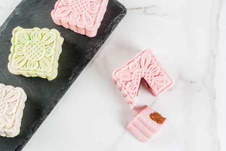 Asian, Japanian food,  Traditional sweet dessert multicolored no bake snow skin mooncakes on white marble table. copy spaceの写真素材