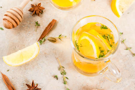 Fall and winter traditional drinks. Warming hot tea with lemon, ginger, spices (anise, cinnamon) and herbs (thyme), copy spaceの写真素材