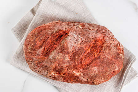 Trendy healthy food, superfood. Homemade beet bread with organic beetroot, on white marble table, copy space top viewの写真素材