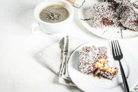 Australian food. Traditional dessert Lamington - pieces of biscuit in dark chocolate, sprinkled with...