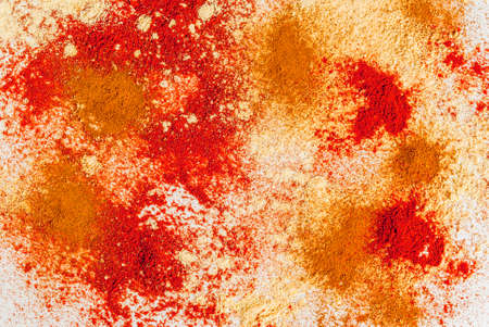Mixture of dried ground spicy, on a white marble table - chili, paprika, curry, turmeric, ginger. Copy space top view, coking spices backgroundの写真素材