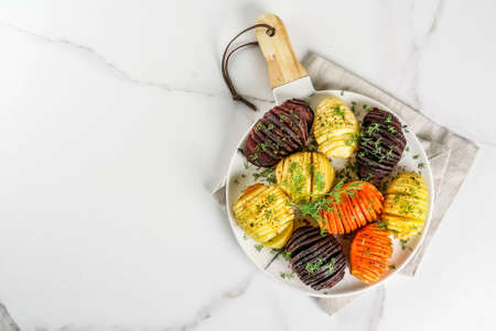 Ideas of vegan food, autumn recipes from vegetables. Roasted Hasselback Beets, carrots, potatoes,...