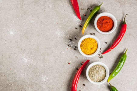 Various spices and seasonings. Cooking background.  Turmeric, curry, paprika, pepper, chili, dried...
