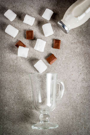 Christmas hot drinks recipes, Set of ingredients for hot chocolate: milk bottle, chocolate, marshmallow. Gray stone background, copy space top viewの写真素材