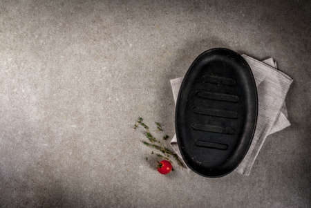 Grey stone culinary background with empty black pan, top view copy spaceの写真素材