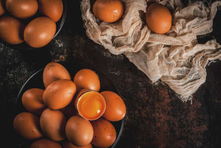 Organic farm chicken eggs, on a plate, on a dark rusty metal background, copy space top viewの写真素材