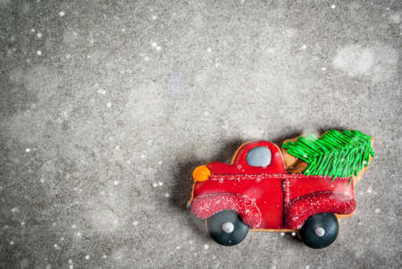 Christmas background homemade colorful gingerbread cookies, in form of a car with a Christmas tree on grey stone table. Top view, copy space verticalの写真素材