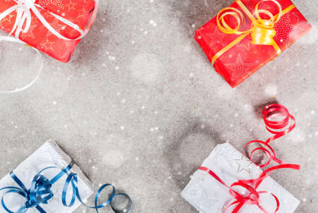 Christmas background with decorated gifts. Gray background, snow effect, Top view copy space frameの写真素材