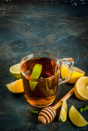 Black tea with lemon and mint on dark blue concrete stone background, copy spaceの写真素材