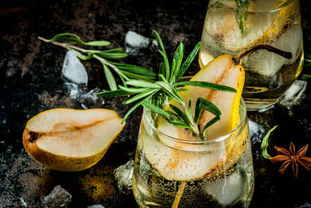 Alcohol drink, Sweet pear cocktail with rum, liquor, anise and rosemary, On a black rusty metallic background, copy spaceの写真素材