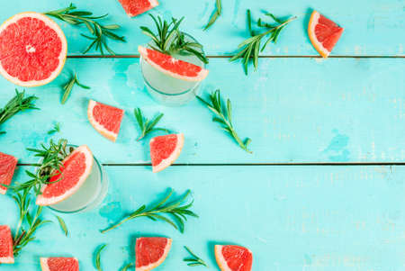 Alcohol drink, Rosemary, Grapefruit & Gin Cocktail, On light blue wooden table background, copy space top viewの写真素材