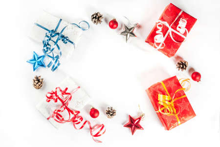 Christmas gift boxes and decorations on white background, top view copy space isolation frame