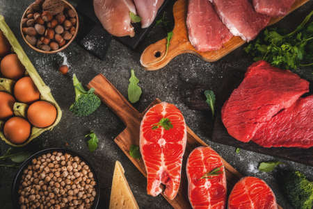 Healthy food background. Selection of protein sources: beef and pork meat, chicken  filet, salmon...