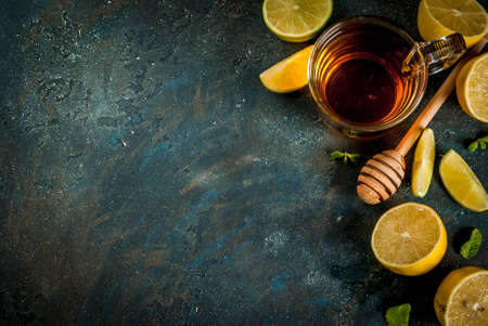 Black tea with lemon and mint on dark blue concrete stone background, copy space top viewの写真素材