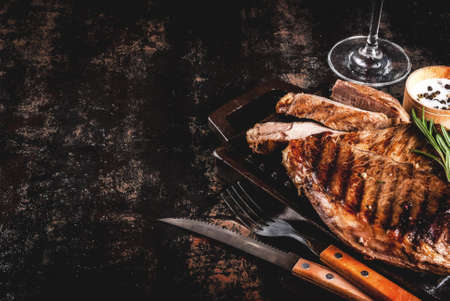 Grilled beef steak with spices on grill pan board, with and red wine glass. Copy spaceの写真素材