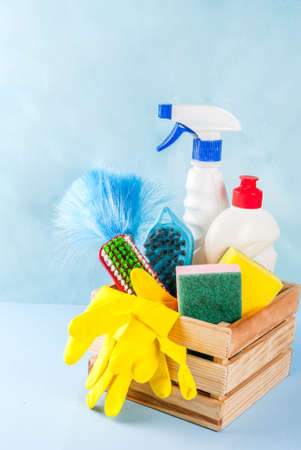 Spring cleaning concept with supplies, house cleaning products pile. Household chore concept, on...