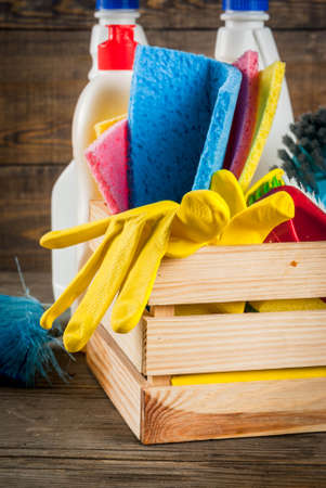 Spring cleaning concept with supplies, house cleaning products pile. Household chore concept, on rustic or garden wooden background copy space の写真素材