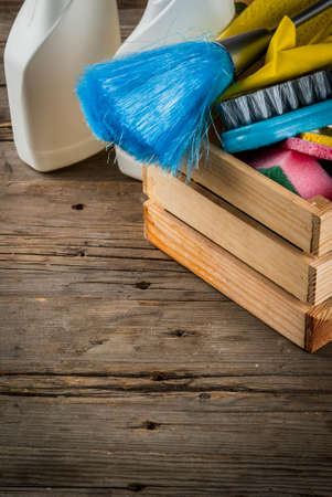 Spring cleaning concept with supplies, house cleaning products pile. Household chore concept, on rustic or garden wooden background copy space の写真素材