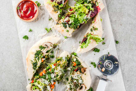 Vegan pizza with fresh vegetables and pesto, gray stone background, copy space top viewの写真素材