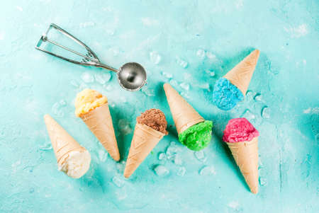 Selection of various bright multicolored ice-cream in ice cream cones - chocolate vanilla blueberry...