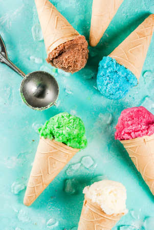 Selection of various bright multicolored ice-cream in ice cream cones - chocolate vanilla blueberry...