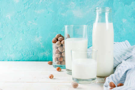 Vegan alternative food, hazelnut non-dairy milk on light blue background, copy spaceの写真素材