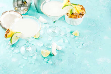 Tropical drink, Frozen Coconut Pineapple Margaritas with frozen pina colada, tequila, pineapple juice and lime,  light blue background, copy spaceの写真素材