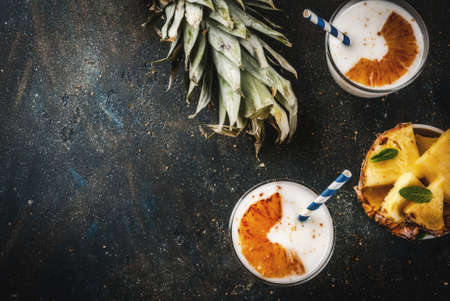 Indian food and drink, Caramelized Pineapple Lassi cocktail, dark blue background copy space top viewの写真素材