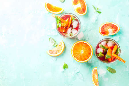 Summer cold drink, blood orange mint cocktail - mimosa, mojito or sangria,  light blue background, copy space top viewの写真素材