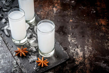 Traditional arabic alcohol drink Raki with anise, dark rusty background copy spaceの写真素材