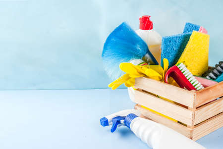 Spring cleaning concept with supplies, house cleaning products pile. Household chore concept, on light blue background copy spaceの写真素材