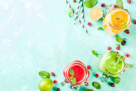 Healthy fresh fruit and veggie smoothies with ingredients on light blue concrete table, copy space top viewの写真素材