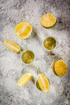Tequila shots with lime and sea salt on grey stone table, copy space top viewの写真素材