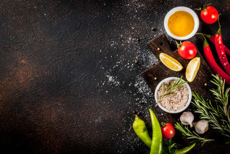 Food cooking ingredient, olive oil, herbs and spices, dark rusty background top view copy spaceの写真素材