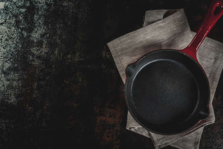 Dark rusty culinary background with empty black pan, top view copy spaceの写真素材