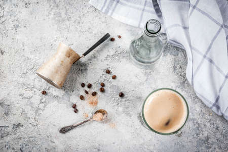 Trendy modern drink. Coffee espresso with mineral water, with coffee maker and roasted beans, Gray stone background, copy space top viewの写真素材