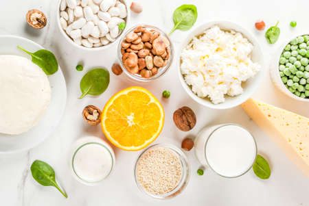 Healthy food concept. Set of food rich in calcium - dairy and vegan Ca products, white marble background top view copy spaceの写真素材