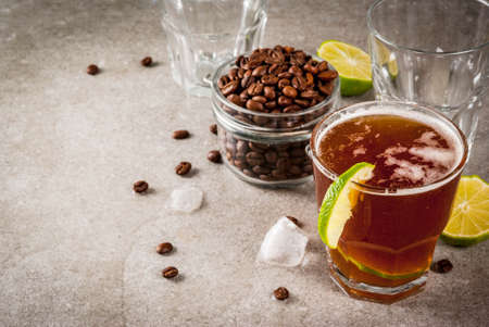 Espresso Tonic, refreshment summer drink with tonic water, lime and coffee, grey stone table, copy...