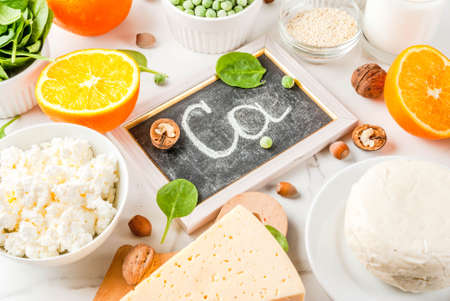 Healthy food concept. Set of food rich in calcium - dairy and vegan Ca products, white marble backgroundの写真素材