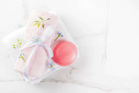 Spa relax and bath concept, sea salt, soap, with cosmetics and towels in bathroom white background, copy spaceの写真素材